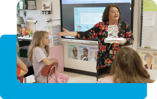 Teacher engaged in lively conversation with middle-school students.